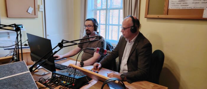 Cllr Stuart Dark reviewing audio Councillor Dark sits with Sound Engineer Richard. They are both wearing headphones as they check the recording using the Sound Desk.