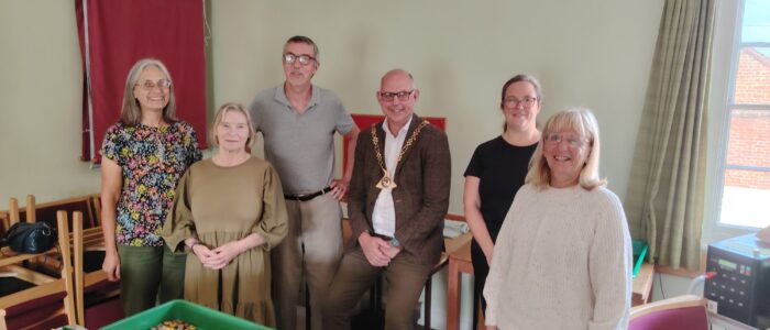 Cllr Stuart Dark with Copy and Dispatch team The Copy and Dispatch team stand together with Councillor Dark in front of a tray of USB memory stick and mailing envelopes.